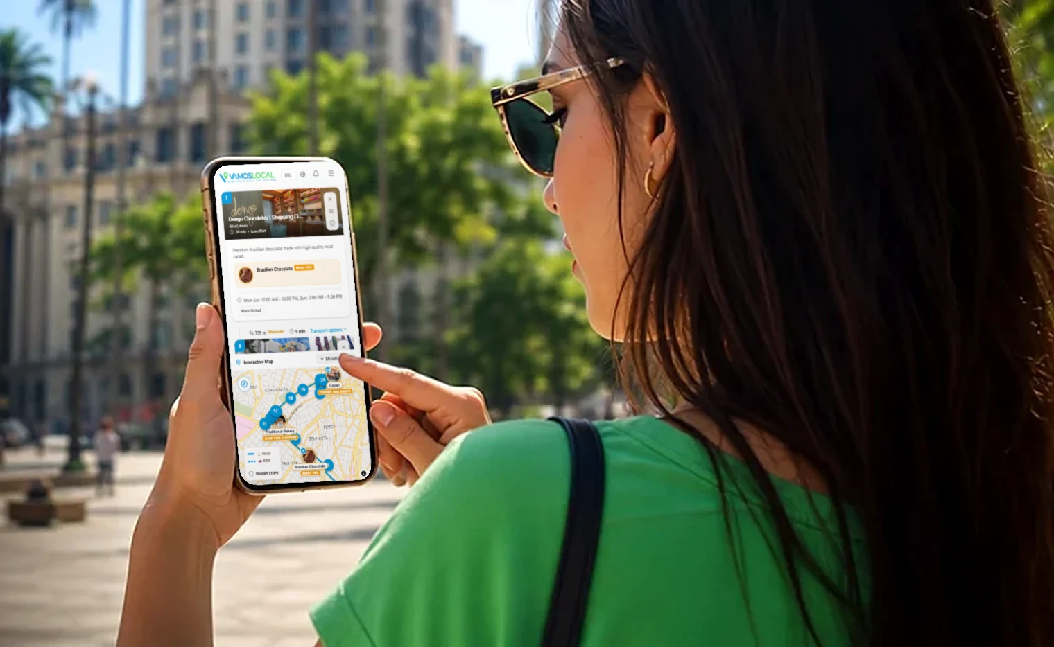 A traveller following a self-guided Vamos route on a phone in São Paulo